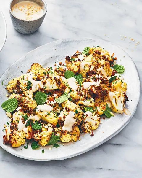 Spice-Roasted Cauliflower with Nut Butter Cream, Almonds & Herbs image
